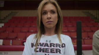 Head coach Monica Aldama of Navarro College cheerleading team in a gym setting.