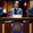 Panel of three men speaking at a table with microphones, including one identified as Doug Logan, during a legislative session regarding election audits. Panel of three men speaking at a table with microphones, including one identified as Doug Logan, during a legislative session regarding election audits.
