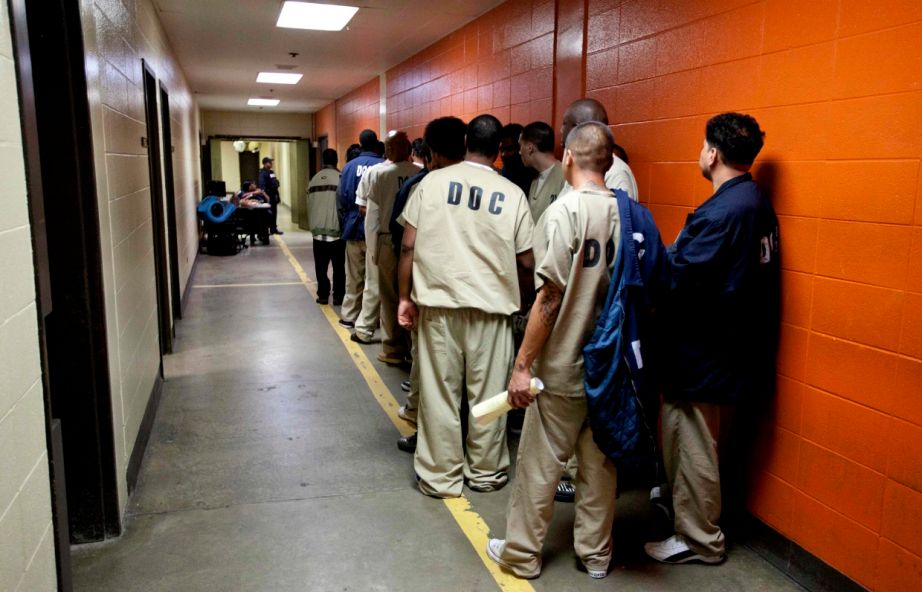 Inmates at the Cook County Jail in Chicago line up to be processed for release on Sept. 29, 2011.