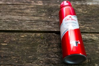 Old Spice talcum powder canister on a wooden surface.