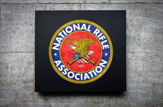 An emblem of the National Rifle Association (NRA) displayed on a wall.