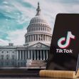 Smartphone displaying TikTok logo in front of the U.S. Capitol building, symbolizing the legislative debate surrounding the app's potential ban in the United States. Smartphone displaying TikTok logo in front of the U.S. Capitol building, symbolizing the legislative debate surrounding the app's potential ban in the United States.