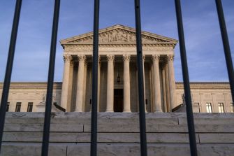 U.S. Supreme Court building viewed through a fence.