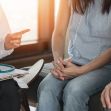 A doctor consulting with a couple in a medical setting. A doctor consulting with a couple in a medical setting.