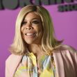 Wendy Williams smiling in front of a pink background with text that reads "Morning Show." Wendy Williams smiling in front of a pink background with text that reads "Morning Show."
