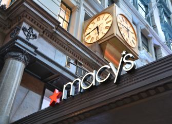 Macy's store entrance featuring the brand's logo and a prominent clock display.