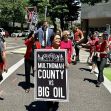 A group of protesters marches in downtown Portland, holding signs that read "Multnomah County vs Big Oil" as they advocate against oil and gas companies. A group of protesters marches in downtown Portland, holding signs that read "Multnomah County vs Big Oil" as they advocate against oil and gas companies.