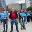 A group of people gathered in an outdoor setting holding signs advocating for gender-affirming care for minors. A group of people gathered in an outdoor setting holding signs advocating for gender-affirming care for minors.