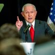 Former Attorney General Jeff Sessions speaking at a podium with American flags in the background. Former Attorney General Jeff Sessions speaking at a podium with American flags in the background.