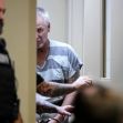 Colin Gray, the father of a Georgia high school shooter, appears in court wearing a striped jail uniform, surrounded by law enforcement officers. Colin Gray, the father of a Georgia high school shooter, appears in court wearing a striped jail uniform, surrounded by law enforcement officers.