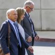 Three individuals walking together outside a building, dressed in formal attire, in relation to a legal case involving sexual abuse allegations. Three individuals walking together outside a building, dressed in formal attire, in relation to a legal case involving sexual abuse allegations.
