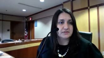 A courtroom scene featuring Judge Kristela Cervera during a virtual hearing related to a homicide case involving a ten-year-old boy.