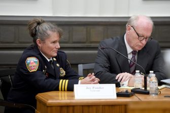 Joy Ponder, a former Asheville City firefighter, seated beside her attorney during a legal proceeding related to her gender discrimination lawsuit.
