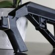 Image of a bump stock firearm accessory placed next to a plant. Image of a bump stock firearm accessory placed next to a plant.