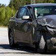 A damaged car on the side of the road after a collision. A damaged car on the side of the road after a collision.