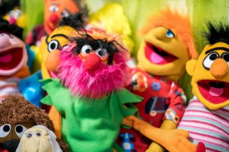A variety of colorful puppets from a children's show, featuring characters with distinct hairstyles and clothing.