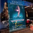 Promotional poster for Shen Yun 2024, showcasing a dancer in traditional attire, displayed in a storefront window. Promotional poster for Shen Yun 2024, showcasing a dancer in traditional attire, displayed in a storefront window.