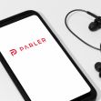 Image of a smartphone displaying the Parler logo alongside earphones. Image of a smartphone displaying the Parler logo alongside earphones.