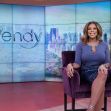 Wendy Williams seated on set with a vibrant backdrop during her television show. Wendy Williams seated on set with a vibrant backdrop during her television show.