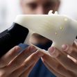 A person holding a 3D-printed gun, demonstrating the untraceable nature of these firearms. A person holding a 3D-printed gun, demonstrating the untraceable nature of these firearms.