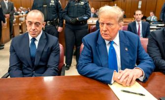 Former President Donald Trump sitting in a courtroom during his trial for falsifying business documents.