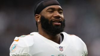 A smiling NFL player wearing a Miami Dolphins uniform.
