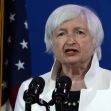 Janet Yellen delivering a speech, with the American flag in the background. Janet Yellen delivering a speech, with the American flag in the background.