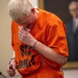 Former attorney Alex Murdaugh in an orange prison jumpsuit appears emotional during his sentencing for financial crimes. Former attorney Alex Murdaugh in an orange prison jumpsuit appears emotional during his sentencing for financial crimes.