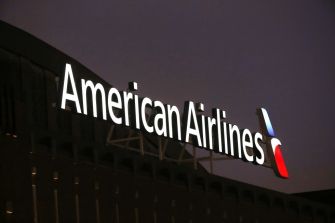 American Airlines sign illuminated at night.