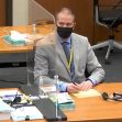 Former police officer Derek Chauvin sitting at a courtroom table during the George Floyd death trial, wearing a mask and taking notes. Former police officer Derek Chauvin sitting at a courtroom table during the George Floyd death trial, wearing a mask and taking notes.