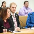 A legislative hearing in Minnesota with three people seated at a table, discussing various issues. A legislative hearing in Minnesota with three people seated at a table, discussing various issues.