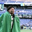 Ahmad "Sauce" Gardner walking on the field of MetLife Stadium, wearing a green hooded cape. Ahmad "Sauce" Gardner walking on the field of MetLife Stadium, wearing a green hooded cape.