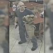 Surveillance image of a diner holding a gun inside a restaurant during a robbery. Surveillance image of a diner holding a gun inside a restaurant during a robbery.
