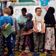 Kindergarten students line up with their books at Gov. James B. Longley Elementary School in Lewiston, Maine. (Brianna Soukup/Portland Press Herald/Getty Images via Pew Research)