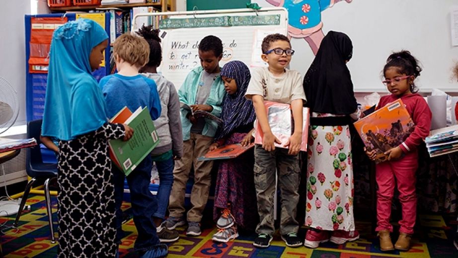 Kindergarten students line up with their books at Gov. James B. Longley Elementary School in Lewiston, Maine. (Brianna Soukup/Portland Press Herald/Getty Images via Pew Research)