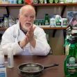 A chemist demonstrating cleaning products in a lab setting, surrounded by various bottles of disinfectants and cleaners. A chemist demonstrating cleaning products in a lab setting, surrounded by various bottles of disinfectants and cleaners.