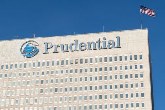 Prudential Financial building with an American flag displayed on top.