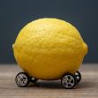 A lemon placed on toy car wheels, symbolizing the California lemon law and its controversies. A lemon placed on toy car wheels, symbolizing the California lemon law and its controversies.