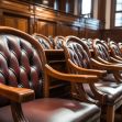 Row of wooden jury chairs in a courtroom. Row of wooden jury chairs in a courtroom.