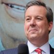 Former Fox News anchor Ed Henry speaking at an event, with a blurred background. Former Fox News anchor Ed Henry speaking at an event, with a blurred background.