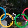 In this March 19, 2021, file photo, people take pictures of the Olympic rings installed by the Japan Olympic Museum in Tokyo. The vaccine rollout in Japan has been very slow with less than 1% vaccinated. This of course is spilling over to concerns about the postponed Tokyo Olympics that open in just over three months.(AP Photo/Hiro Komae, File)