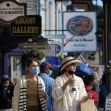 Visitors walk on a busy sidewalk, Saturday, May 15, 2021, in Bar Harbor, Maine. Gov. Janet Mills is is eliminating most outdoor distancing requirements imposed during the COVID-19 pandemic as the tourism season begins to kick into gear. (AP Photo/Robert F. Bukaty)