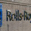 Signage of Rolls-Royce displayed on a brick wall. Signage of Rolls-Royce displayed on a brick wall.