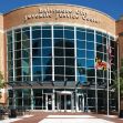 Baltimore City Juvenile Justice Center exterior with large glass windows and a banner overhead. Baltimore City Juvenile Justice Center exterior with large glass windows and a banner overhead.