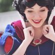 A performer in a Snow White costume smiling and expressing joy. A performer in a Snow White costume smiling and expressing joy.