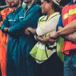 Group of workers wearing safety vests and uniforms standing together, possibly in a labor or union context. Group of workers wearing safety vests and uniforms standing together, possibly in a labor or union context.