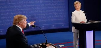 Image of Donald Trump and Hillary Clinton during a presidential debate, with Trump speaking passionately and Clinton listening.