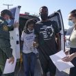 A border patrol agent interacts with a Haitian family recently detained, as they navigate the complexities of migration and border policies in the United States. A border patrol agent interacts with a Haitian family recently detained, as they navigate the complexities of migration and border policies in the United States.
