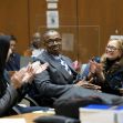 A man sitting in a courtroom surrounded by supporters, smiling and clapping as he celebrates his exoneration after being wrongfully convicted. A man sitting in a courtroom surrounded by supporters, smiling and clapping as he celebrates his exoneration after being wrongfully convicted.