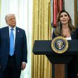 Alina Habba speaking at a podium with the presidential seal, while Donald Trump listens. Alina Habba speaking at a podium with the presidential seal, while Donald Trump listens.